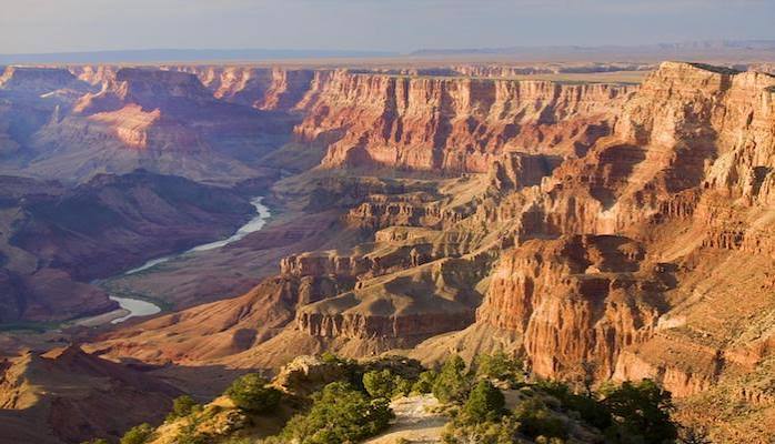 The Grand Canyon from the South Rim at sunset, the Colorado River winding through the gorge below